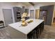Modern kitchen with a large island, stainless steel appliances, gray cabinets, and stylish decor at 9732 N Penworth Dr, Casa Grande, AZ 85122