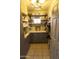 Well-organized pantry with gray cabinets, open shelves, and light countertops for storage at 9732 N Penworth Dr, Casa Grande, AZ 85122