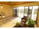 Covered patio features a ceiling fan and large sliding glass doors leading to the outdoor pool area at 9732 N Penworth Dr, Casa Grande, AZ 85122