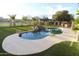 Beautifully landscaped pool with rock waterfall feature and well-maintained green lawn at 9732 N Penworth Dr, Casa Grande, AZ 85122
