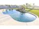 Kidney-shaped swimming pool with a rock waterfall feature and stone coping at 9732 N Penworth Dr, Casa Grande, AZ 85122