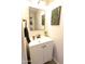 Updated powder room features a modern vanity, mirror, and decor at 9732 N Penworth Dr, Casa Grande, AZ 85122