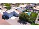 Inviting backyard featuring a sparkling pool, lush artificial grass, and a charming seating area with BBQ at 9732 N Penworth Dr, Casa Grande, AZ 85122