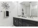 Bright bathroom features double sinks, dark cabinets, and a large mirror with decorative accents at 9807 S 11Th St, Phoenix, AZ 85042