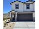 Charming two-story home featuring neutral paint, a dark gray garage door and desert landscaping at 9807 S 11Th St, Phoenix, AZ 85042