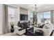 Stylish living room featuring modern furniture, TV, light wood floors, and light-filled window at 9807 S 11Th St, Phoenix, AZ 85042