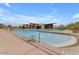 Modern community pool with lounge chairs, desert landscaping and a mountain backdrop at 9807 S 11Th St, Phoenix, AZ 85042
