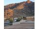 Mountain view streetscape with partial brick wall and desert landscaping in the foreground at 9807 S 11Th St, Phoenix, AZ 85042