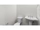 Clean half-bathroom with a pedestal sink and a low-flow toilet at 3856 E Sagebrush St, Gilbert, AZ 85296