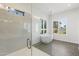 Bright bathroom featuring a glass-enclosed shower and a standalone soaking tub under shuttered windows at 3856 E Sagebrush St, Gilbert, AZ 85296