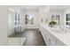 Modern bathroom with dual sinks, a glass-enclosed shower, tub, and bright natural light at 3856 E Sagebrush St, Gilbert, AZ 85296