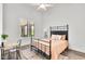 Sunlit bedroom with neutral tones, a metal bed frame, and a charming desk area at 3856 E Sagebrush St, Gilbert, AZ 85296