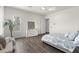 Clean bedroom with wood floors, a decorative cabinet, and bright, shuttered windows, next to bed at 3856 E Sagebrush St, Gilbert, AZ 85296