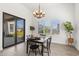Bright dining room featuring a modern chandelier, plantation shutters, and tile floors at 3856 E Sagebrush St, Gilbert, AZ 85296