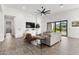 Bright living room featuring a ceiling fan, tile floors, and access to an outdoor living space at 3856 E Sagebrush St, Gilbert, AZ 85296