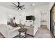 Open living room featuring neutral paint, a ceiling fan, and modern tile floors at 3856 E Sagebrush St, Gilbert, AZ 85296