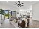 Open-concept living room featuring a ceiling fan with access to the kitchen and outdoor area at 3856 E Sagebrush St, Gilbert, AZ 85296