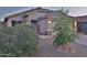 Charming single-story home features a tile roof, desert landscaping, and inviting entry at 803 W Burkhalter Dr, San Tan Valley, AZ 85143