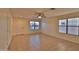 Bright living room featuring tile floors, a ceiling fan, and large windows providing ample natural light at 803 W Burkhalter Dr, San Tan Valley, AZ 85143