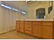 Well-lit bathroom with a double vanity, tile flooring, and a large mirror at 803 W Burkhalter Dr, San Tan Valley, AZ 85143
