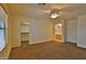 Spacious bedroom with carpet flooring, ceiling fan, ensuite bath, and a walk-in closet for ample storage at 803 W Burkhalter Dr, San Tan Valley, AZ 85143