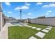 Back yard with pristine pool, diving board, pavers, artificial turf and privacy fence at 8215 E Virginia Ave, Scottsdale, AZ 85257