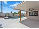 Covered backyard patio featuring concrete flooring, ceiling fan, outdoor pass through, and pristine pool at 8215 E Virginia Ave, Scottsdale, AZ 85257