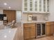 Modern bar area with wine fridge, white cabinets, and countertop, perfect for entertaining guests at 8215 E Virginia Ave, Scottsdale, AZ 85257
