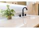Modern bathroom sink features sleek black fixtures, a white countertop, and a minimalist design at 8215 E Virginia Ave, Scottsdale, AZ 85257