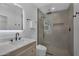 Bright bathroom featuring single sink vanity with a glass shower with tile surround and rainfall shower head at 8215 E Virginia Ave, Scottsdale, AZ 85257