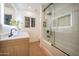 Modern bathroom featuring a glass shower, wood vanity, and sleek fixtures, with white and bright aesthetic at 8215 E Virginia Ave, Scottsdale, AZ 85257