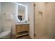 Bright bathroom with a backlit mirror, a modern vanity, and a glass-enclosed shower for spa-like elegance at 8215 E Virginia Ave, Scottsdale, AZ 85257