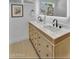 Bright bathroom featuring double sink vanity with white countertop and matte black fixtures and tile flooring at 8215 E Virginia Ave, Scottsdale, AZ 85257