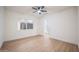 Bright bedroom with wood floors, a ceiling fan, a bathroom viewable from the window, and modern design at 8215 E Virginia Ave, Scottsdale, AZ 85257