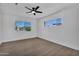Bedroom with a ceiling fan and a large window offering views of the neighborhood at 8215 E Virginia Ave, Scottsdale, AZ 85257