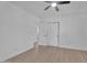 Bright bedroom with light hardwood floors, white walls, a ceiling fan, and closet with sliding doors at 8215 E Virginia Ave, Scottsdale, AZ 85257