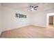Spacious, bright bedroom with wood flooring, a ceiling fan, and a window, creating a serene atmosphere at 8215 E Virginia Ave, Scottsdale, AZ 85257