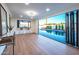 Bonus room features a bar and folding doors that open to the sparkling pool at 8215 E Virginia Ave, Scottsdale, AZ 85257