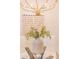 Contemporary dining table centerpiece with elegant chandelier above at 8215 E Virginia Ave, Scottsdale, AZ 85257