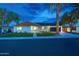 Charming single-story home with modern design, clean lines and landscaped front yard at dusk at 8215 E Virginia Ave, Scottsdale, AZ 85257