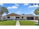 Inviting single-story home with manicured lawn, modern walkway, and neutral paint scheme under a partly cloudy blue sky at 8215 E Virginia Ave, Scottsdale, AZ 85257