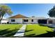 Charming single-story home with a well-manicured lawn and modern walkway to the front entrance at 8215 E Virginia Ave, Scottsdale, AZ 85257