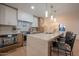 Bright kitchen with stainless steel appliances, island seating, and modern lighting fixtures at 8215 E Virginia Ave, Scottsdale, AZ 85257