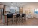 Modern kitchen with island, bar stools, stainless steel appliances, and adjacent dining area at 8215 E Virginia Ave, Scottsdale, AZ 85257