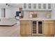 The kitchen features custom wood cabinetry, stone countertops, and an undercounter wine fridge at 8215 E Virginia Ave, Scottsdale, AZ 85257