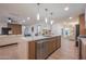 Spacious kitchen island with seating and stainless steel dishwasher in a modern, open layout at 8215 E Virginia Ave, Scottsdale, AZ 85257