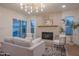 Inviting living room with a fireplace, comfortable seating, and access to the backyard pool at 8215 E Virginia Ave, Scottsdale, AZ 85257