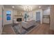 Comfortable living room with fireplace, contemporary light fixture, and stylish rug on hardwood floors at 8215 E Virginia Ave, Scottsdale, AZ 85257