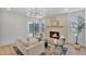 Living room with a brick fireplace, elegant chandelier, and sliding glass doors at 8215 E Virginia Ave, Scottsdale, AZ 85257