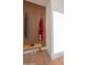 A modern mudroom with a wooden bench, coat hooks, and natural light at 8215 E Virginia Ave, Scottsdale, AZ 85257